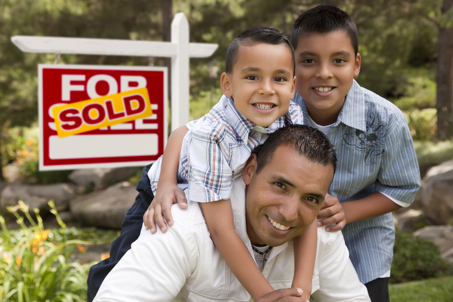 Hispanic Father and Sons in Front of a Sold Home For Sale Real E